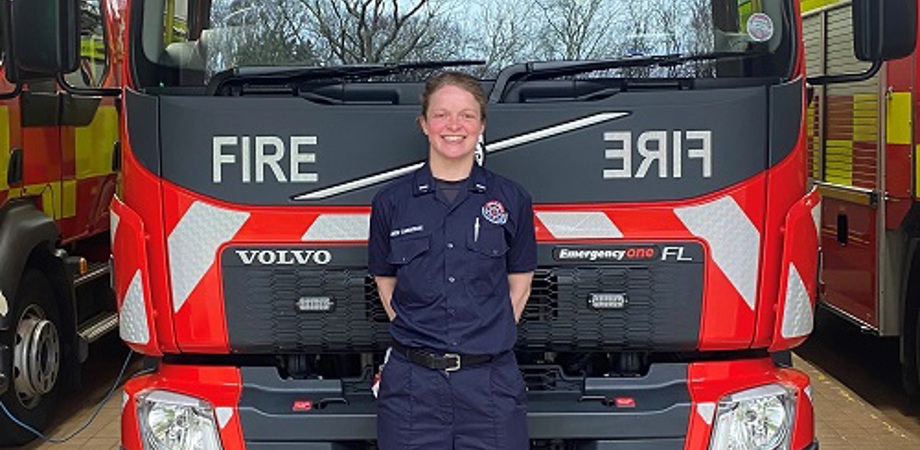 Leading Firefighter Amber Carridge in front of a fire truck